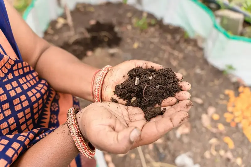 A woman holding a handful of soil
