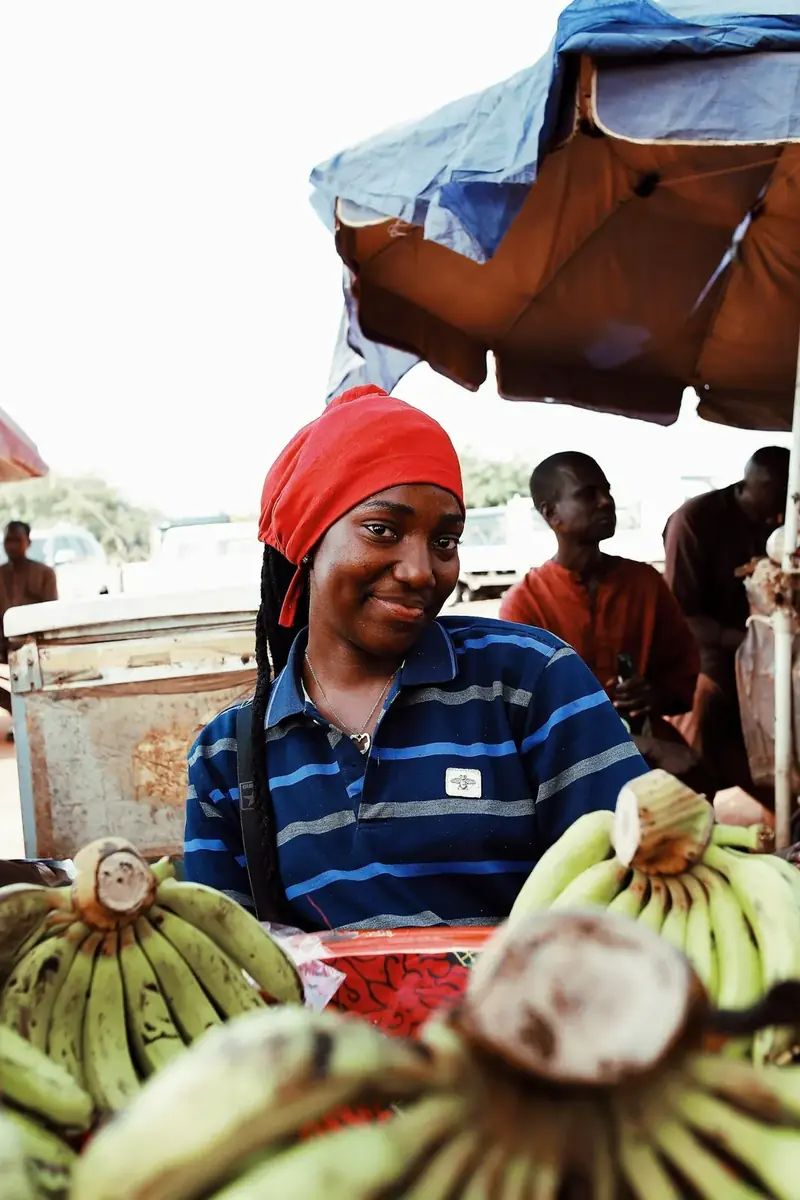 A trader with bananas at a market